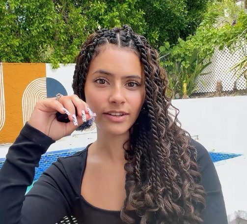 Puerto Rican OnlyFans creator Naomi Daze with braids by a pool