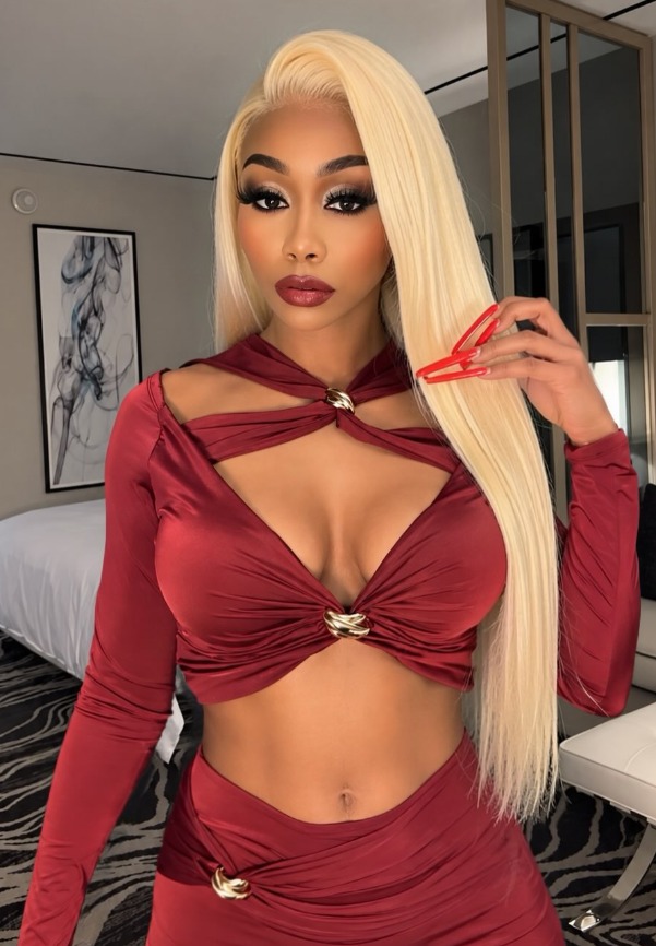 Pinkydoll, viral NPC star and ebony OnlyFans creator, with long blonde hair in a red cut-out outfit